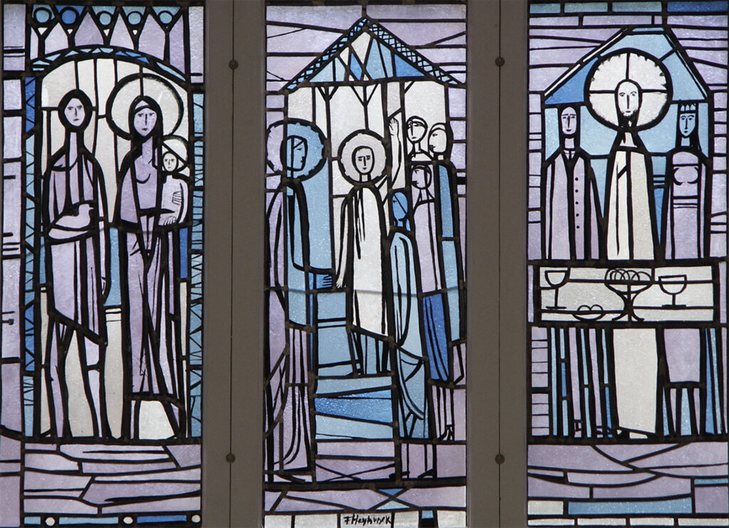 Stained-glass window with stylized biblical figures, halos, and simple architectural forms arranged in three vertical panels.