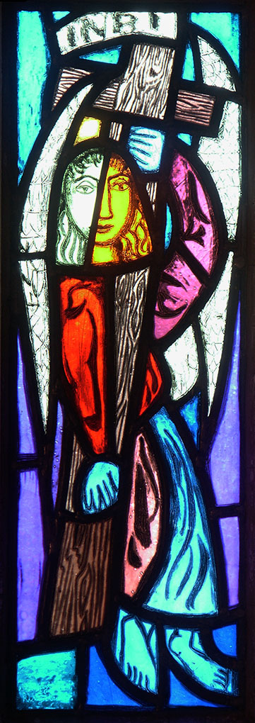 Vibrant stained-glass panel showing a stylized angel in divided colors, surrounded by bold shapes, carrying a wooden cross, with bright hues.