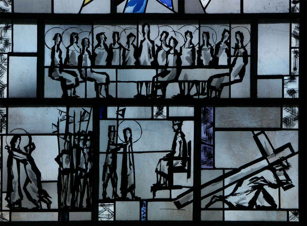 Stained-glass window with bold black sketches showing the Last Supper, arrest scenes, a trial, and a figure carrying a large cross.