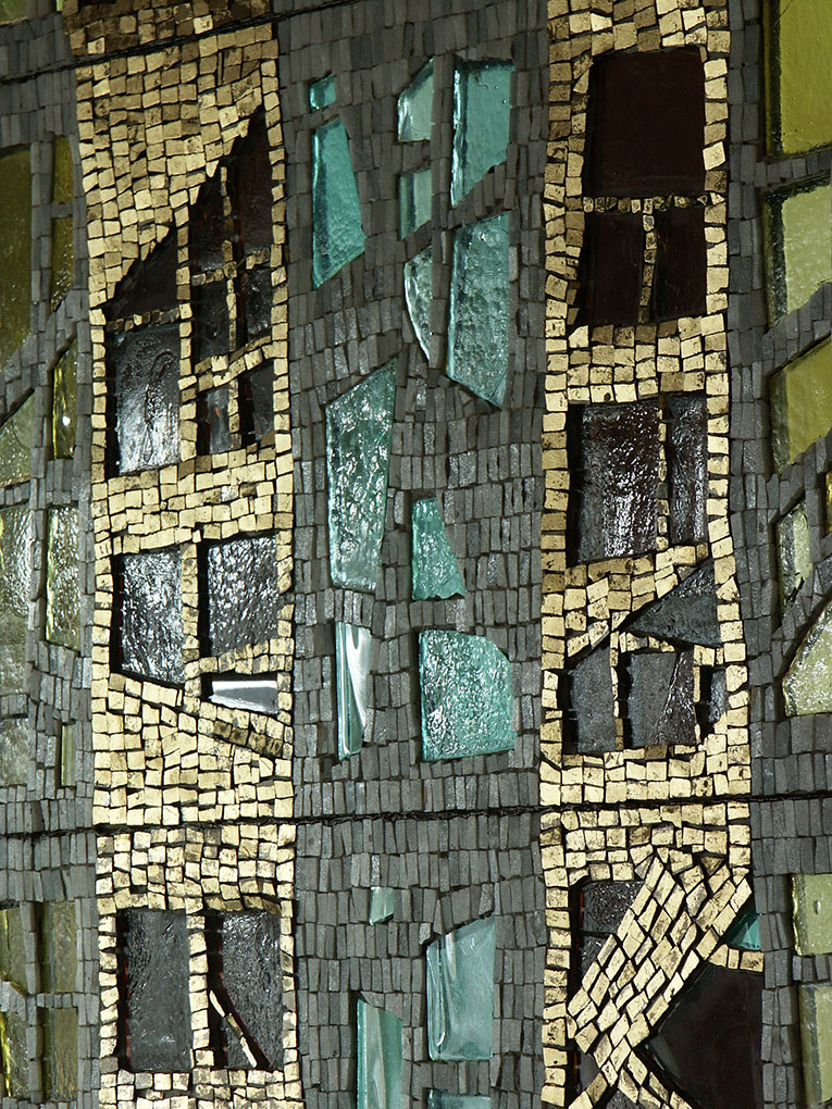 Close-up of mosaic with teal and dark glass pieces framed by dense gold and gray tiles, forming abstract geometric window-like patterns.