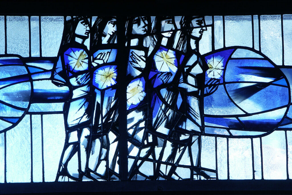Vibrant blue stained-glass scene showing a procession of abstract, elongated figures holding glowing star-like shapes, framed by geometric panels.