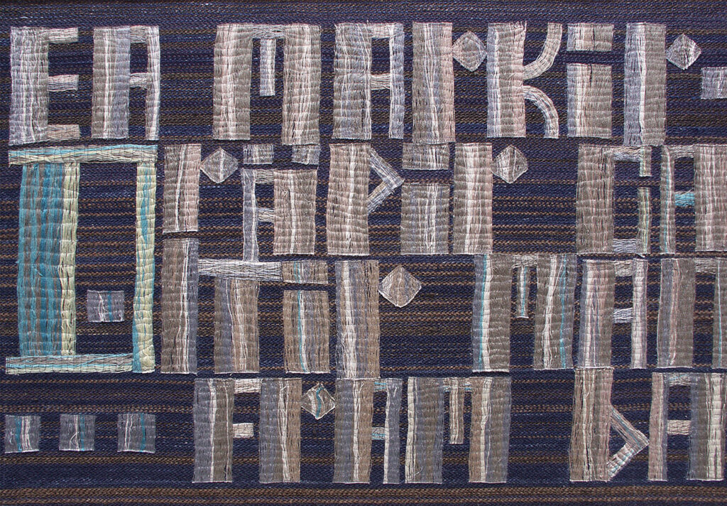 Textile artwork with light geometric letter shapes woven over a dark striped surface in blue and brown tones.