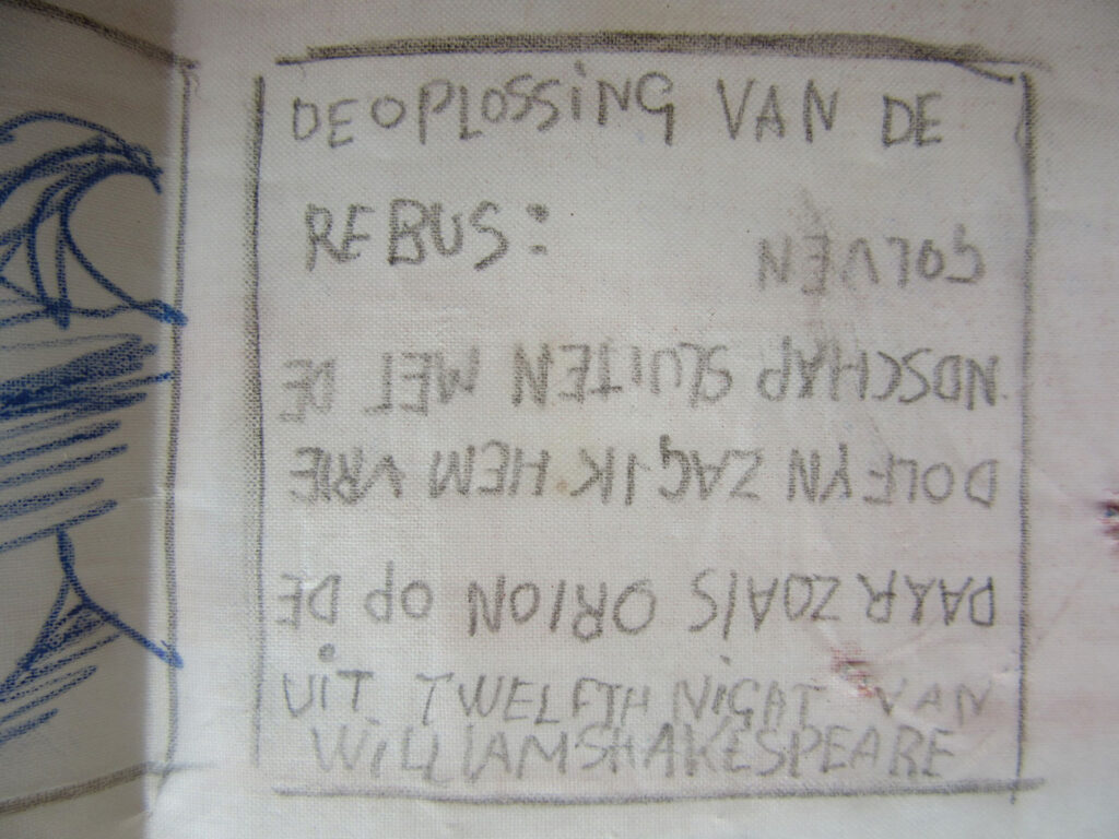 Handwritten Dutch text in a framed box on fabric, discussing the solution to a rebus and referencing Shakespeare’s Twelfth Night.